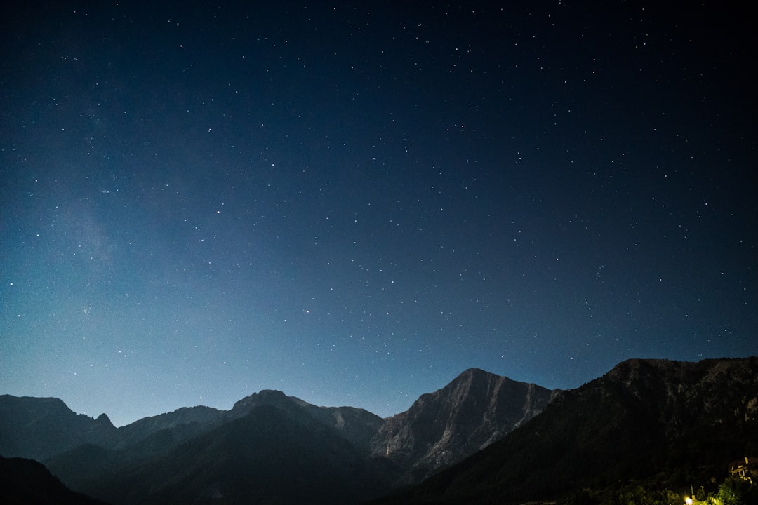 silhouette of mountains during starry night,
