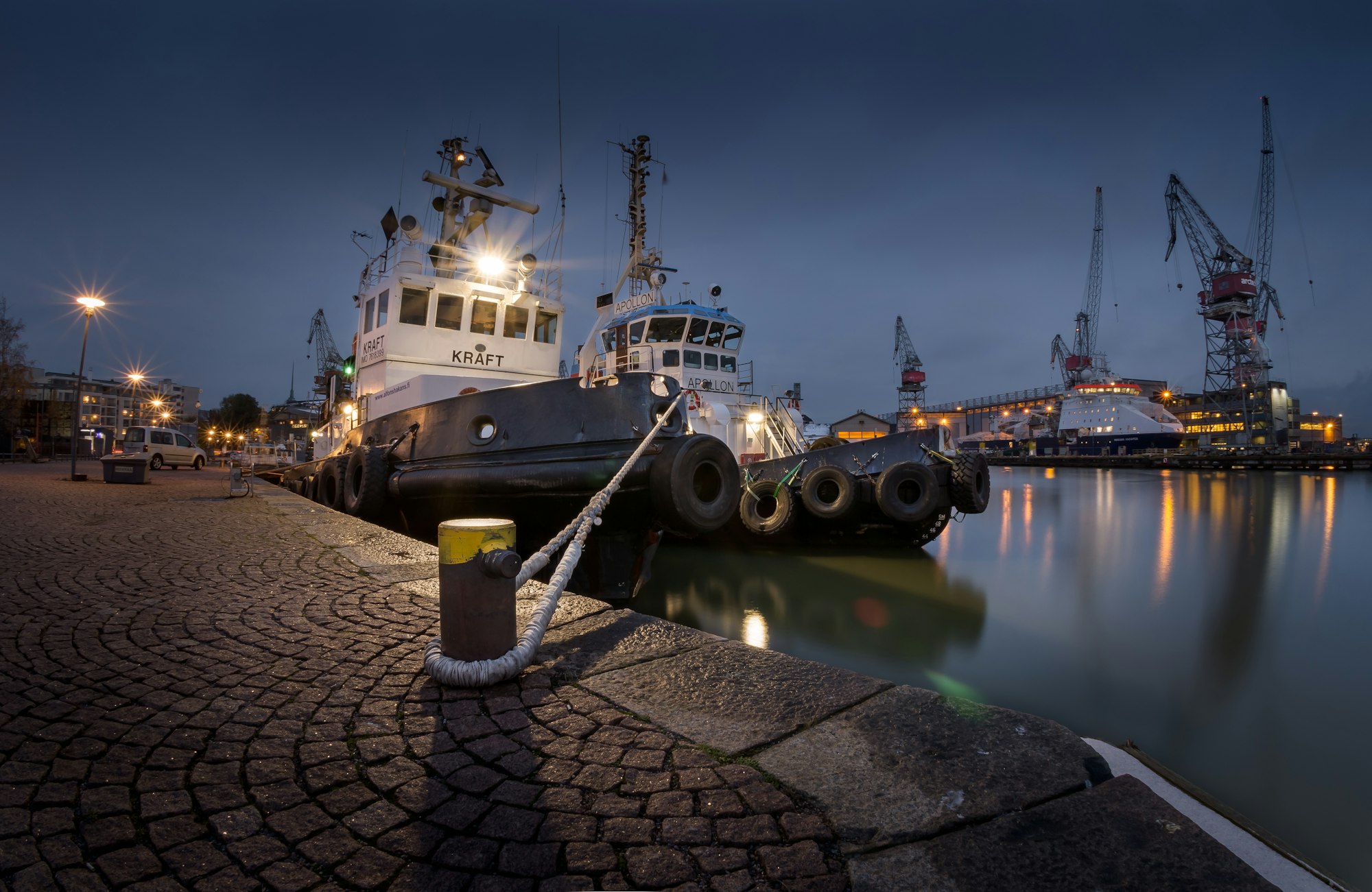 Tugboats maneuvers vessels by pushing or towing them. Workhorses of the sea as they are, they aren’t perhaps the most attractive vessels by appearance, but very powerful and agile. Conveniently, the name ‘Kraft’ actually means ‘power’ in Swedish. These two were visiting the dockyard in southern Helsinki. The shot is a bracketed, 3 exposure shot taken with an ultra wide lens.