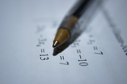black retractable pen on white printer paper