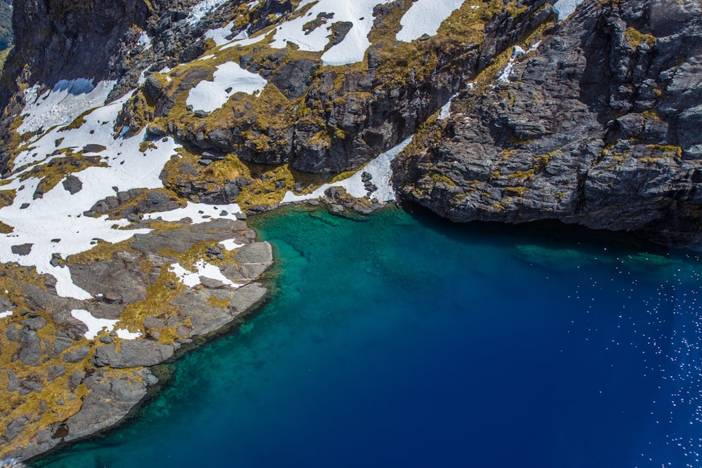 aerial view of body of water near large rocks