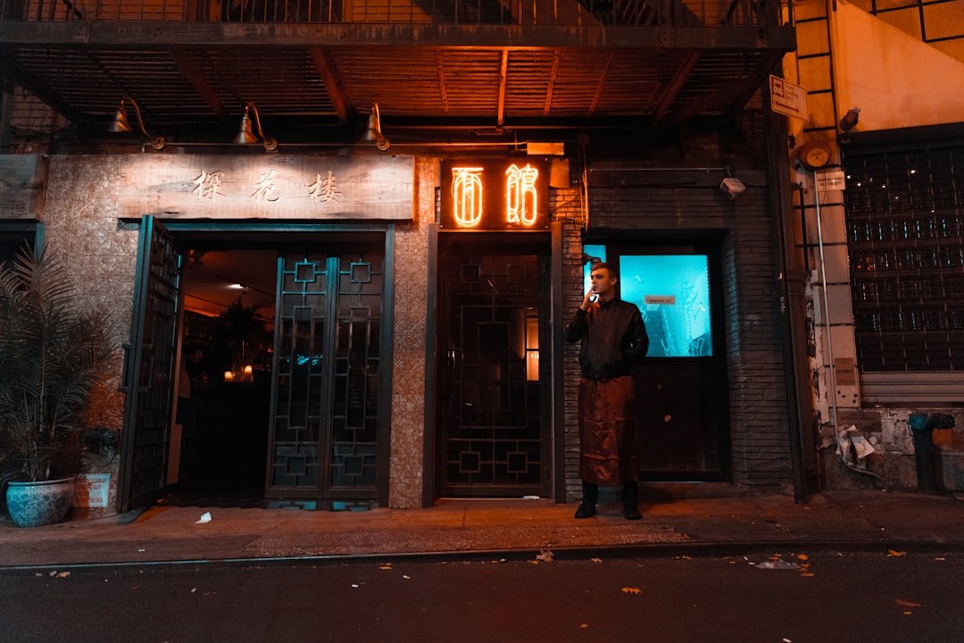 man standing near house during night