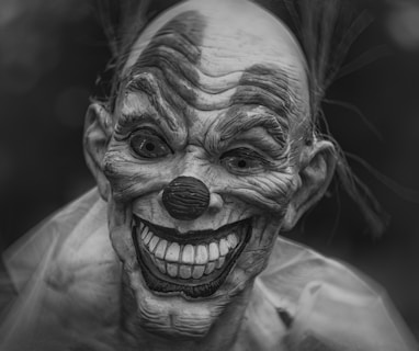 grayscale photography of person wearing clown mask