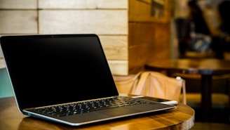 turned off black laptop computer on table