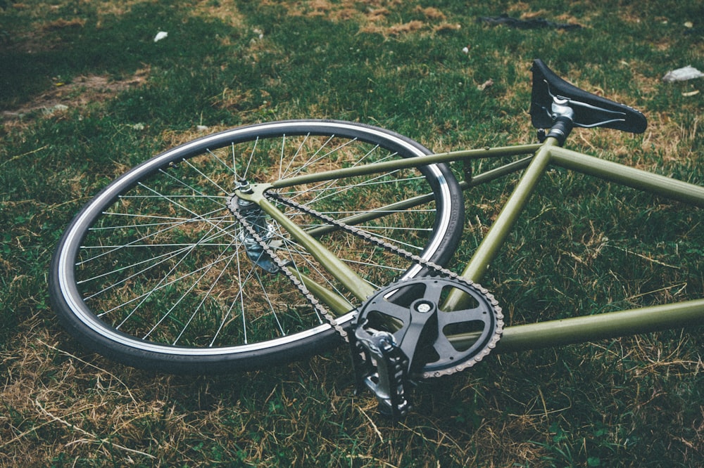 bicycle down on green grass field