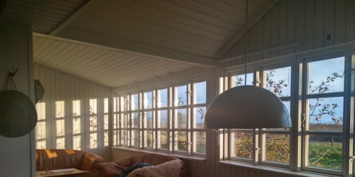 A cozy living room with large windows and natural light.