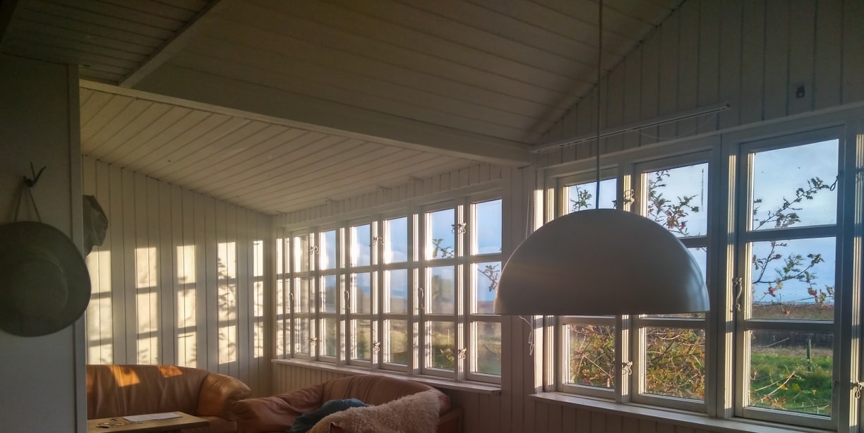 A cozy modern living room with large windows and natural light