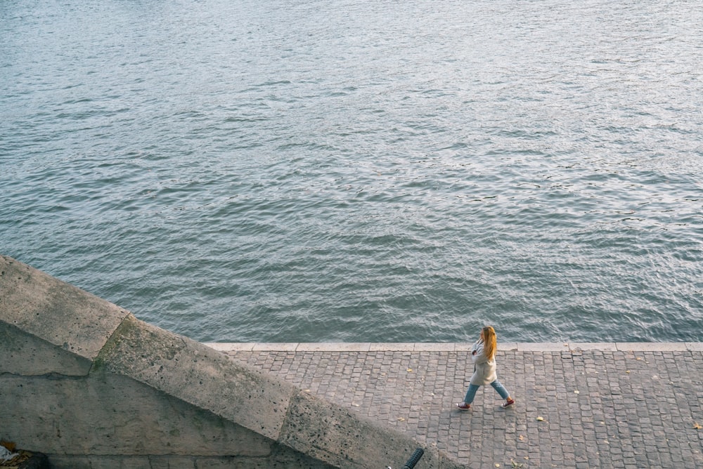 woman walking near ocean