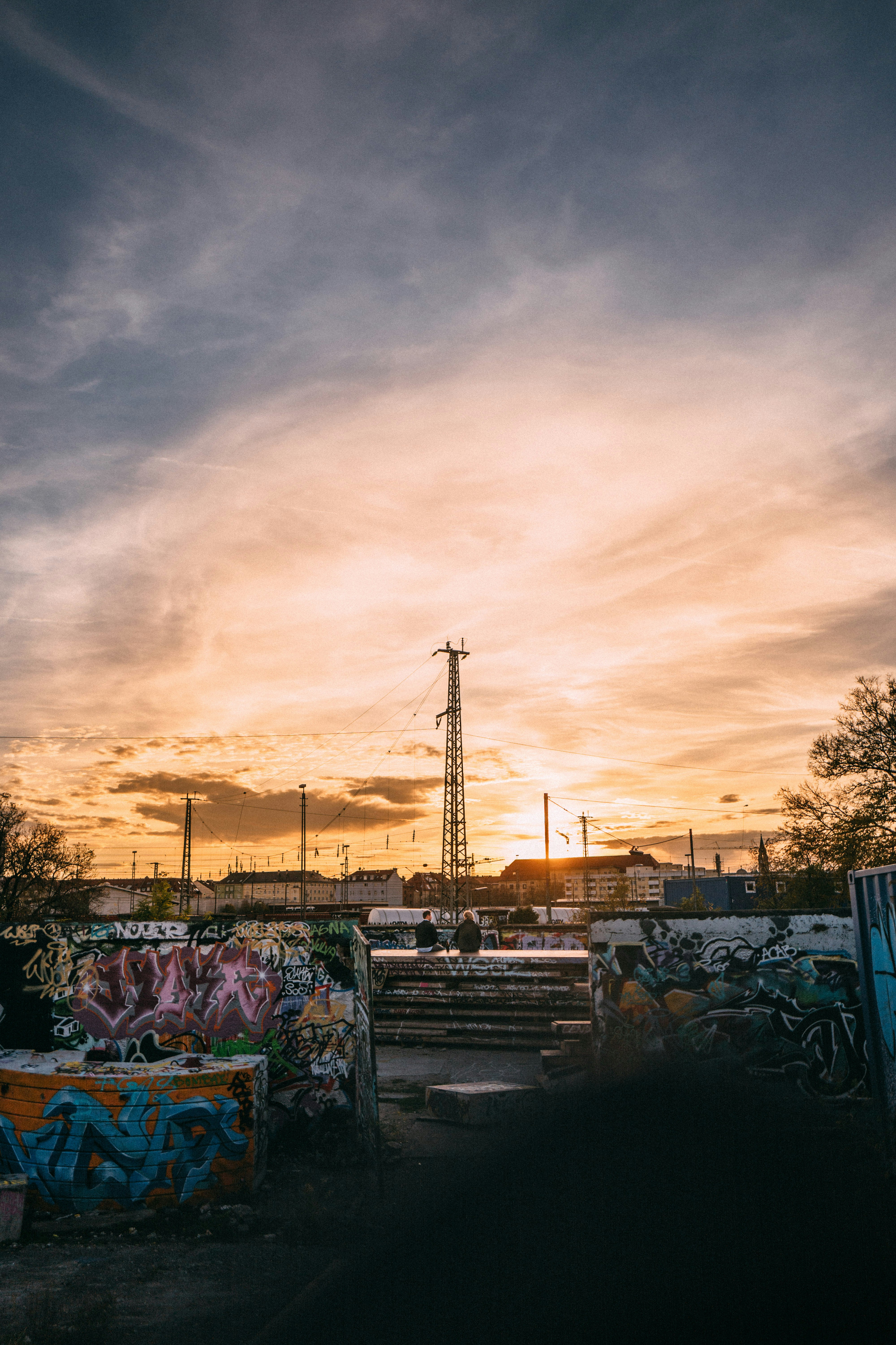 two men sitting near street post