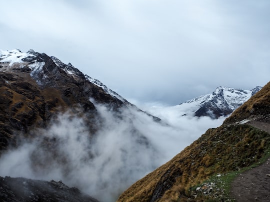 snow cover mountain with gray cloudy skies in Salcantay Peru