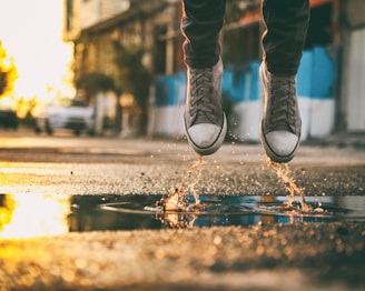 A stylish pair of floatshoe sneakers on a vibrant urban street.