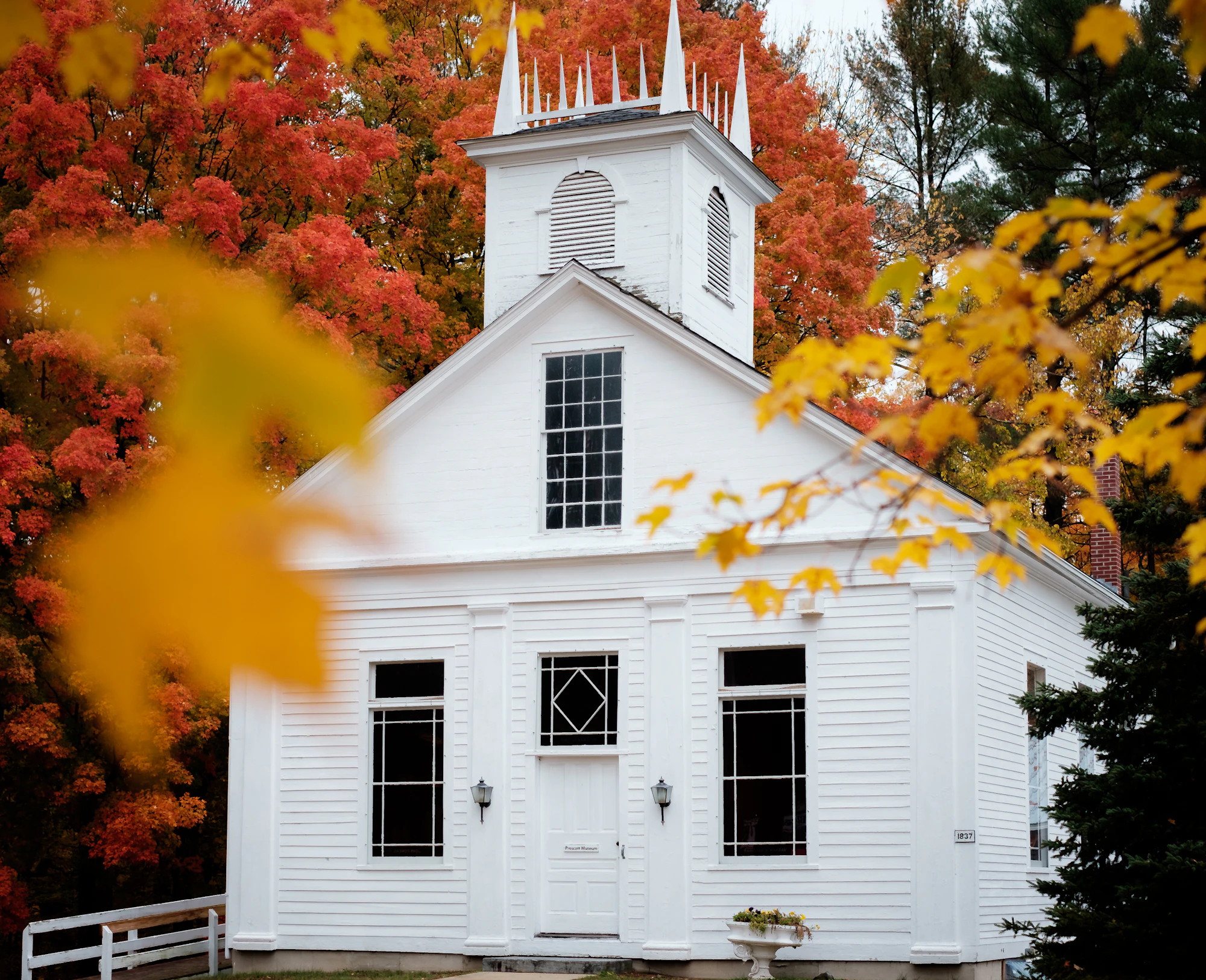 A white New England meetinghouse in autumn