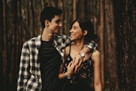 man wrapping arm on woman facing each other