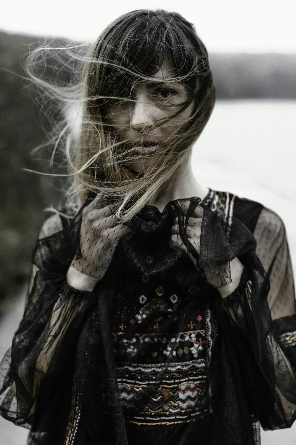 shallow focus photography of woman holding lace textile