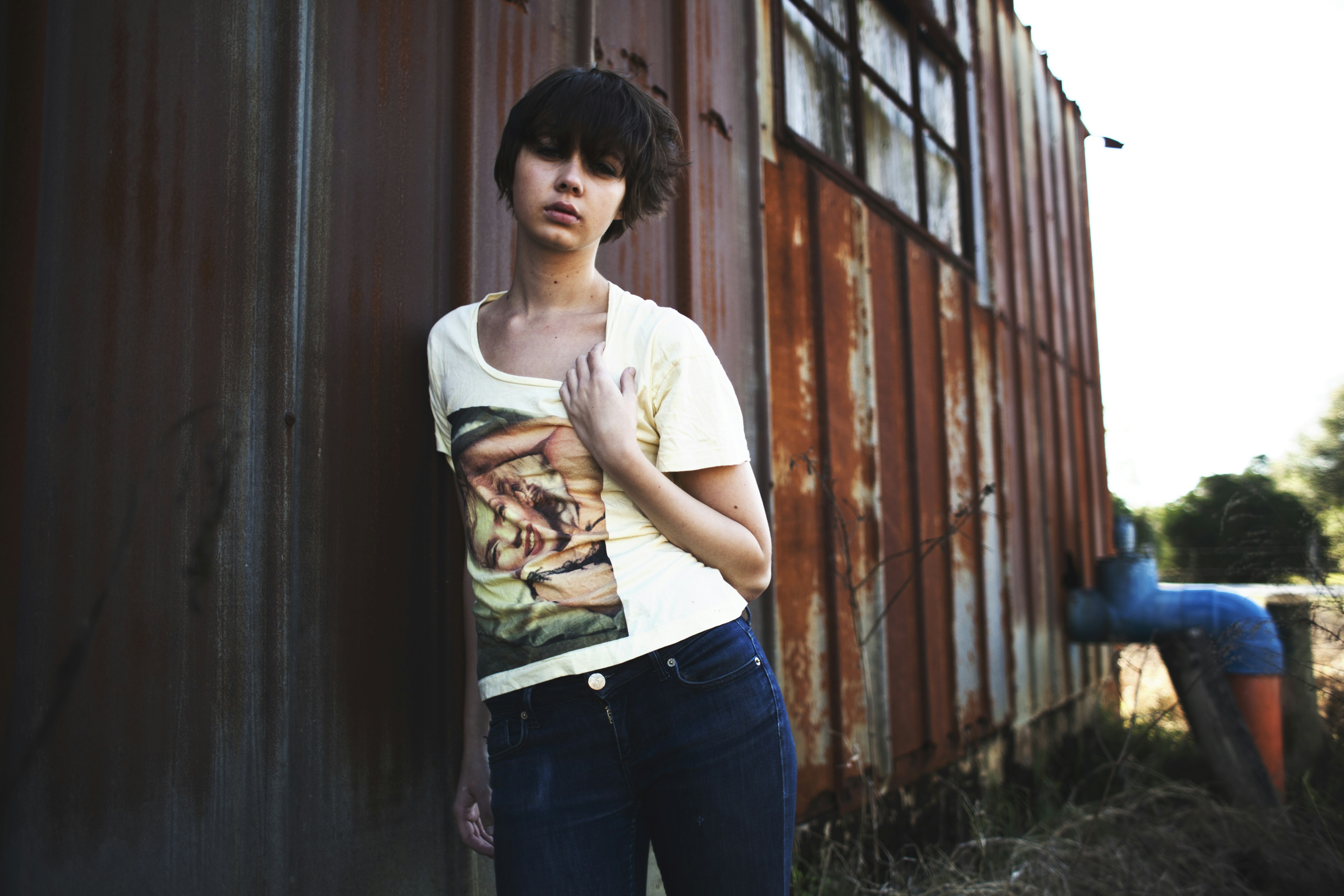 woman leaning on brown steel house