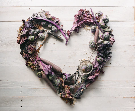 top view of leaves and assorted items formed into heart