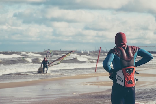 man standing near man in body of water in Sopot Poland