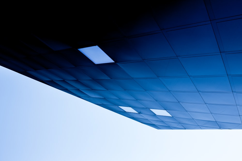 low angle photography of blue building