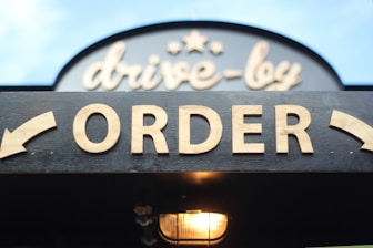 order signage on grey wooden plank