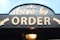 order signage on grey wooden plank