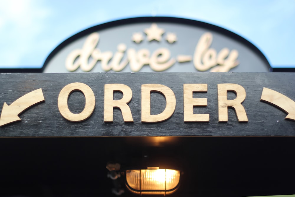 order signage on grey wooden plank