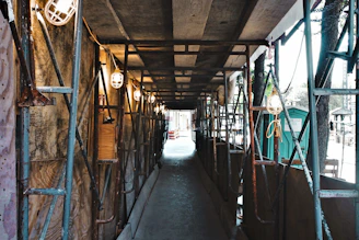 Compact scaffold setup inside a narrow building corridor.