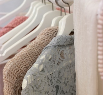 clothes hanging on white rack