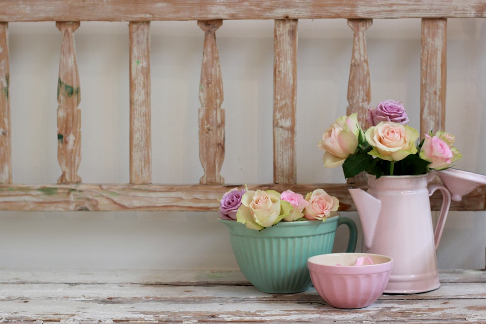 photo of petaled flowers with vase and watering can