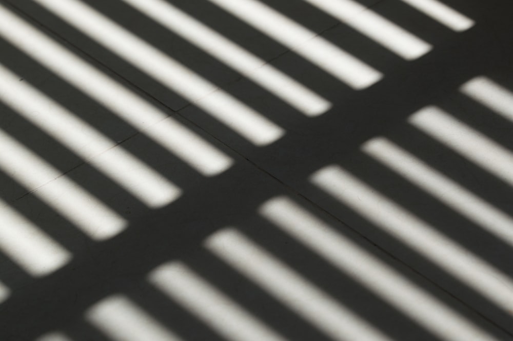 the shadow of a bench on the ground