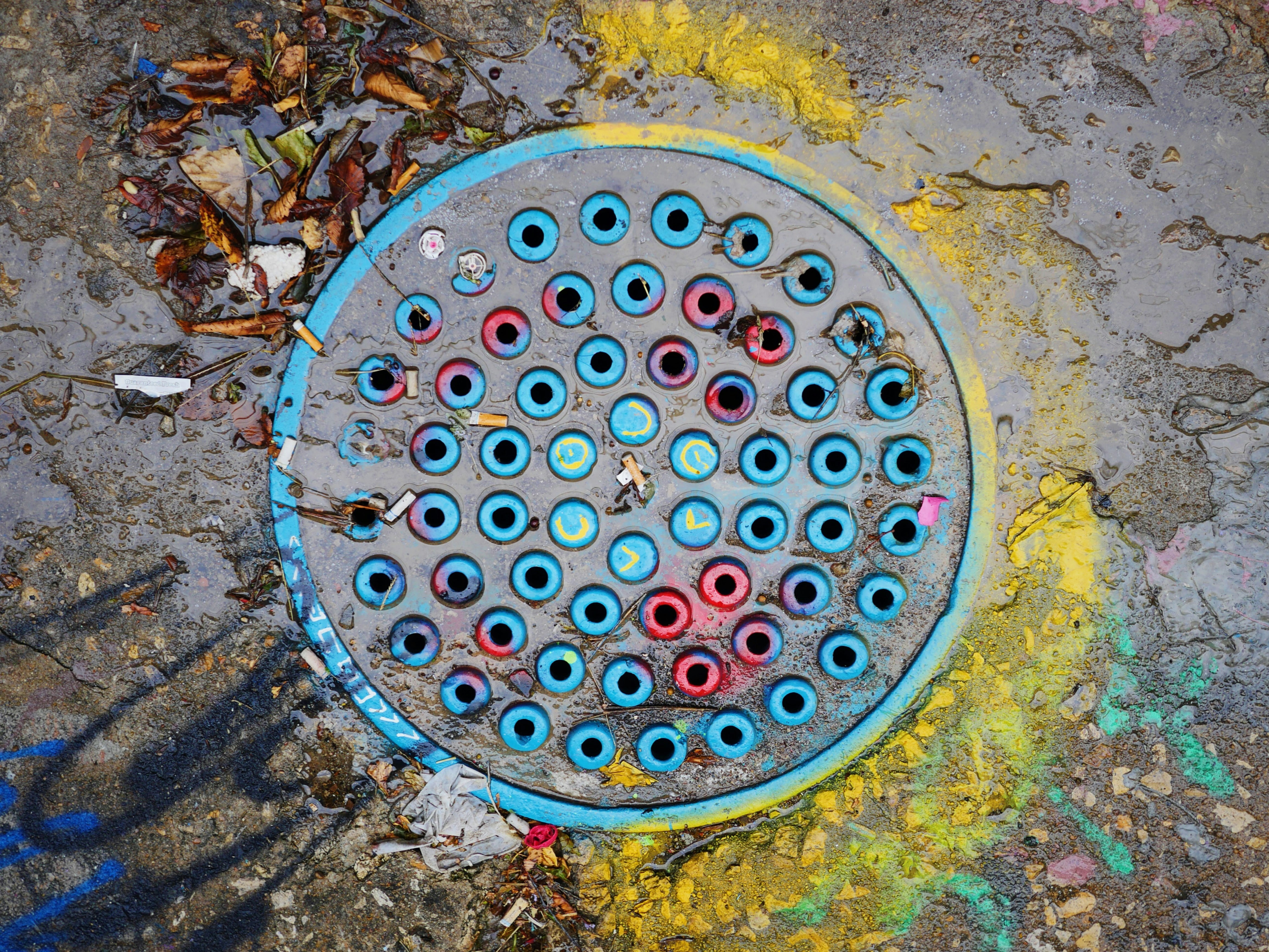 photo of black and blue manhole cover