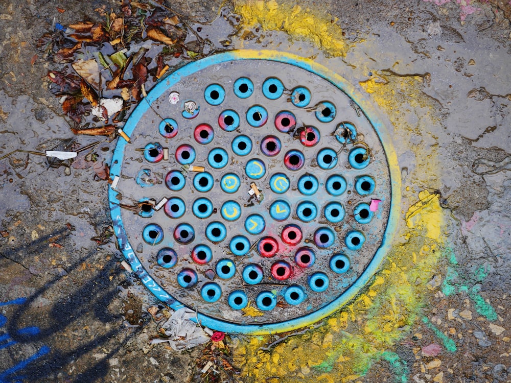 photo of black and blue manhole cover