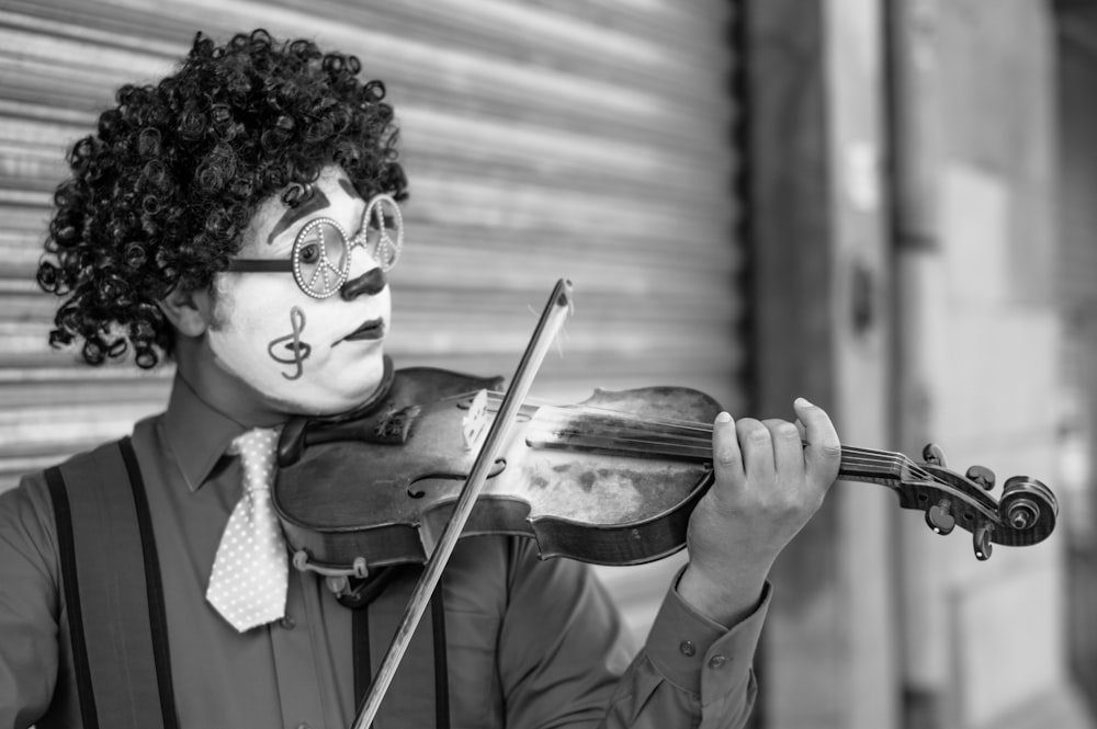 grayscale photo of man playing violin