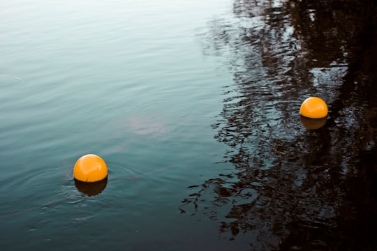 two orange balls on body of water in Hudsonville United States