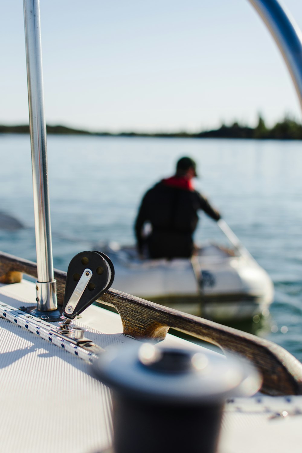 shallow focus photography of man sitting riding boat