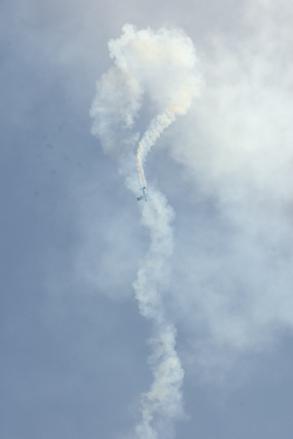biplane bursting white smoke on air