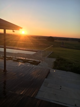 Sunset view over a modern landscaped garden with ambient outdoor lighting and stone pathways.