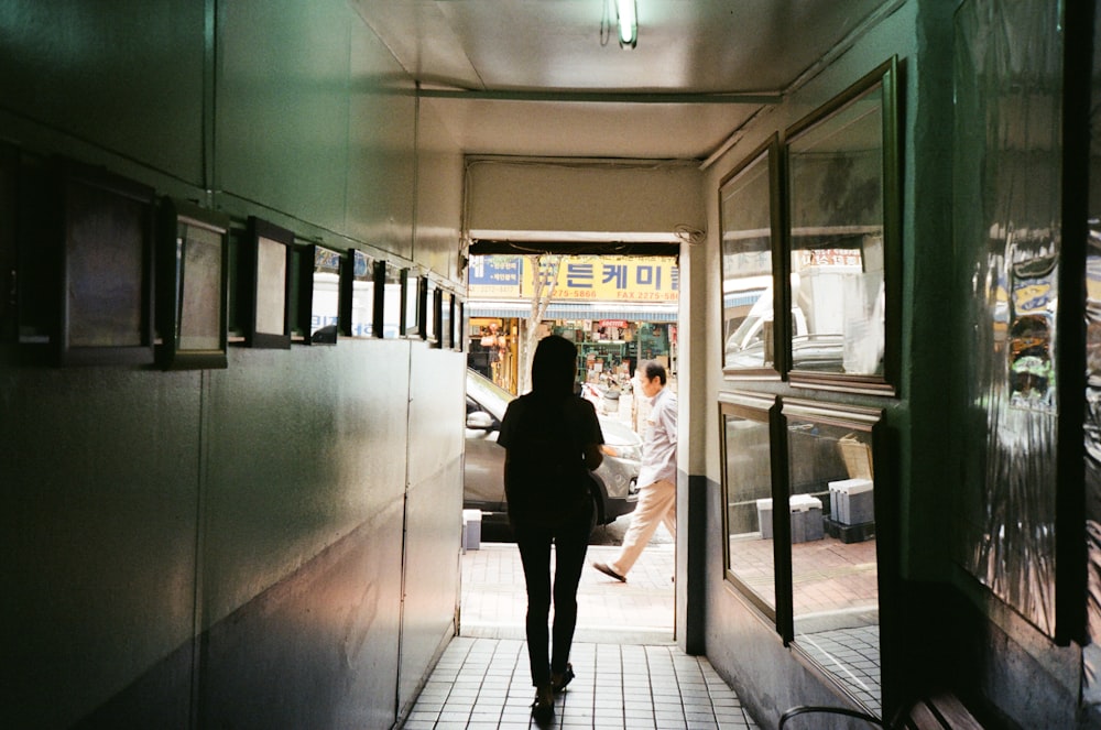 silhouette of a woman walking at the corridor