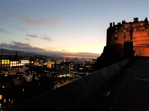 A panoramic view of Edinburgh’s skyline at dusk, highlighting its blend of historic and modern architecture.