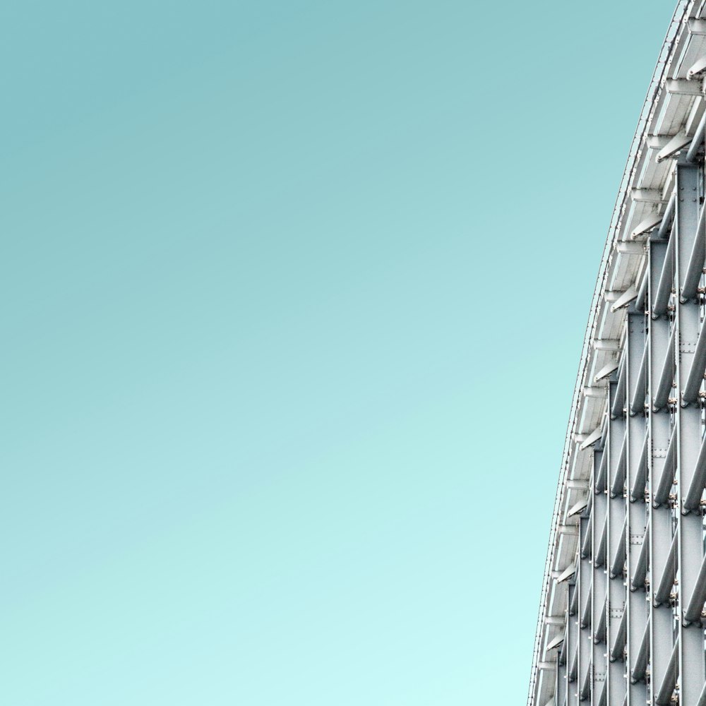 a close up of a metal structure with a sky background