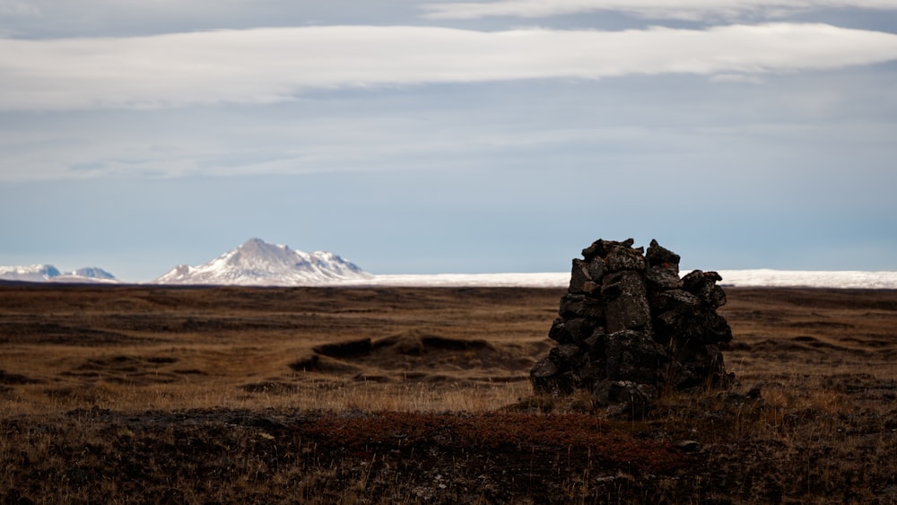 pile of rocks on plain under blue sky at daytime