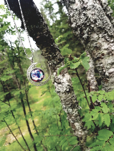 A layered display of zodiac pendants symbolizing family connections, set against a soft celestial backdrop.