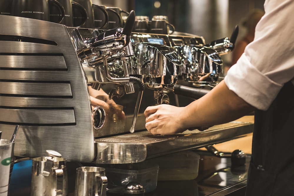 person using espresso machine