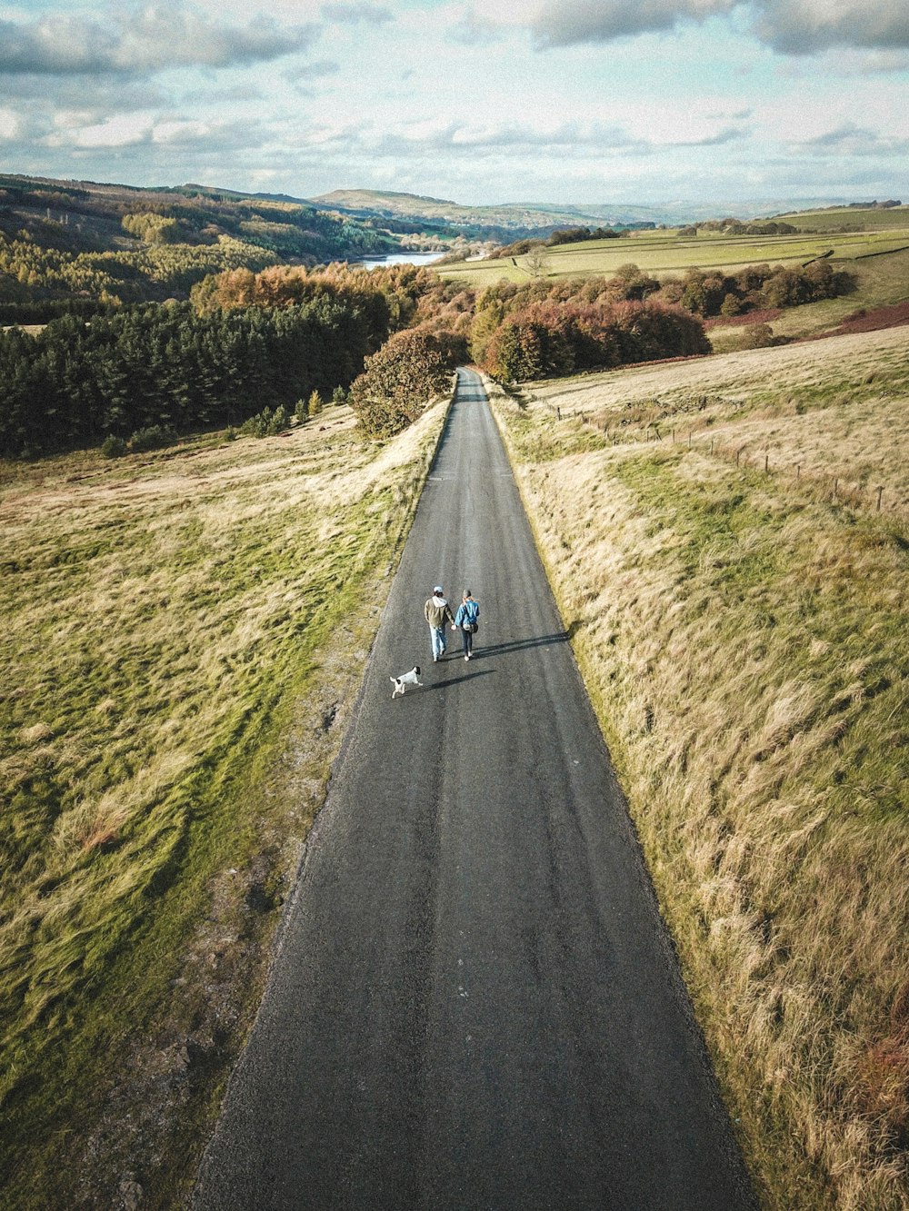 two men walking on road