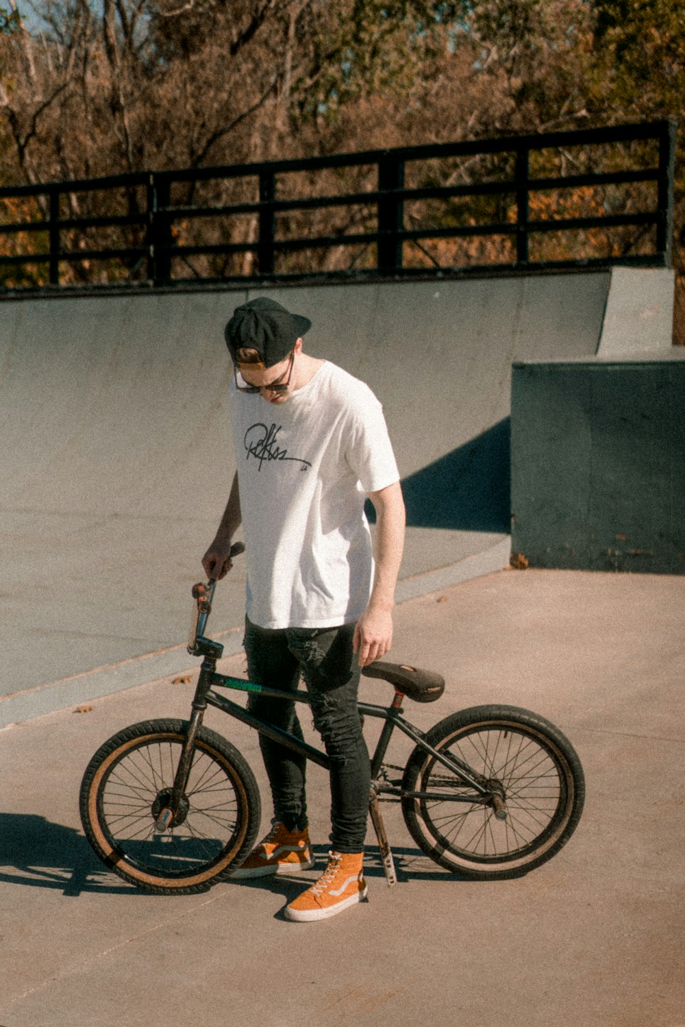 man about to ride on a black BMX bike