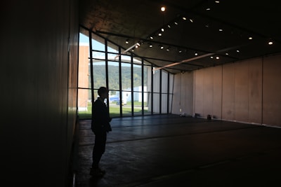 A real estate agent showing a property to potential buyers in a bright, open space.