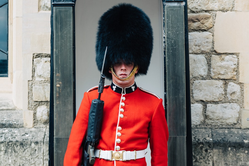 guard standing near brown wall