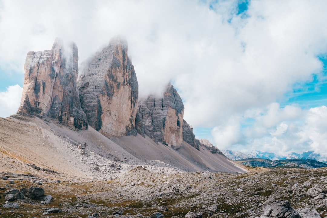 gray and brown rock formation under white clouds