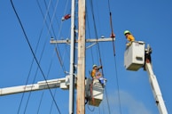 two linemen on cherry pickers