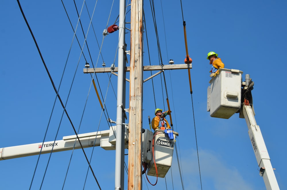 two linemen on cherry pickers