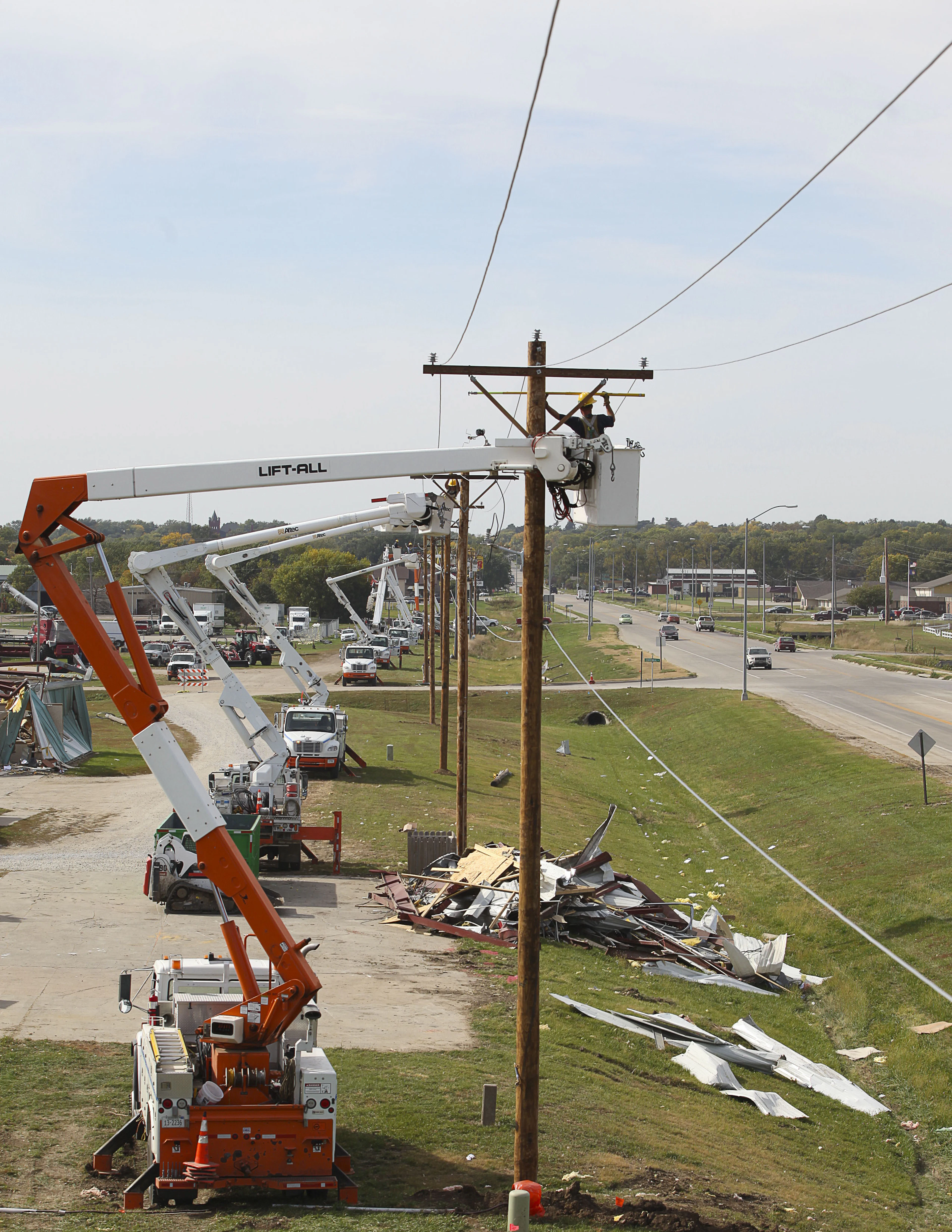 Crane truck beside a utility pole during line work