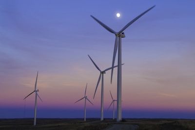 five windmills in front of ocean